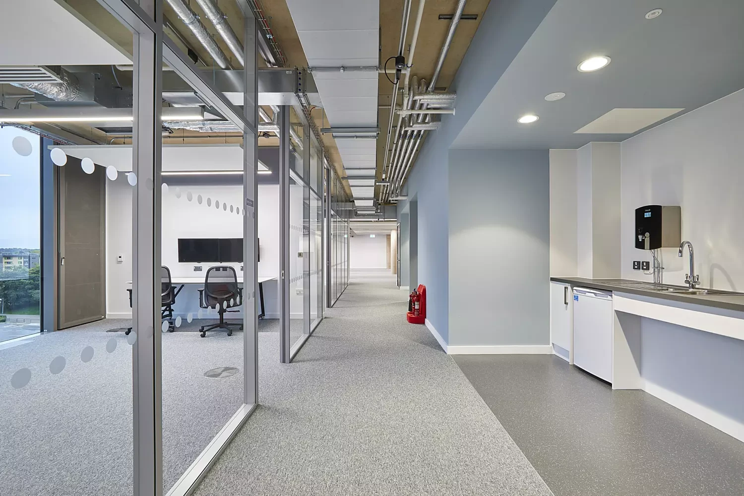 Glazed meeting rooms, exposed services and finished wall junctions