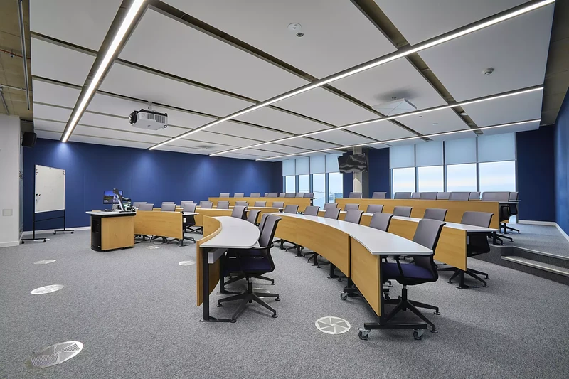 Tiered seating beneath suspended ceiling panels