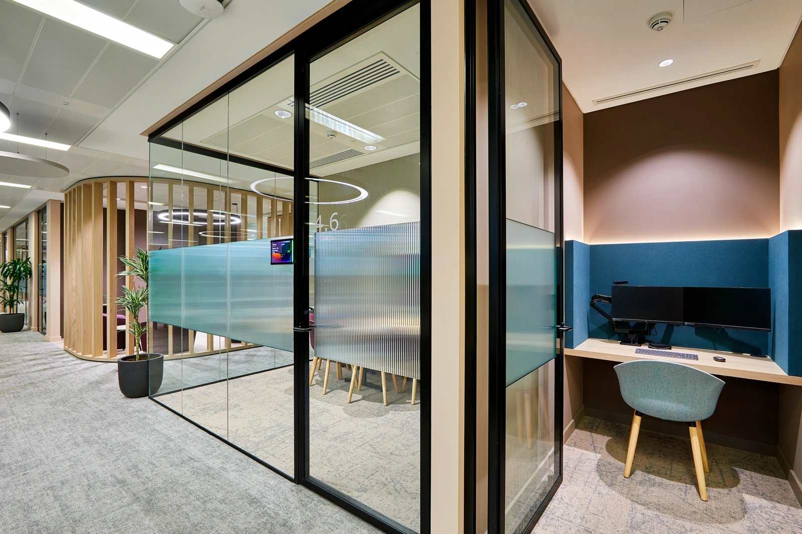 Timber fins, glazed room fronts and a recessed work setting