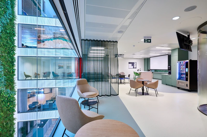 Informal seating and shared meeting space beside the atrium