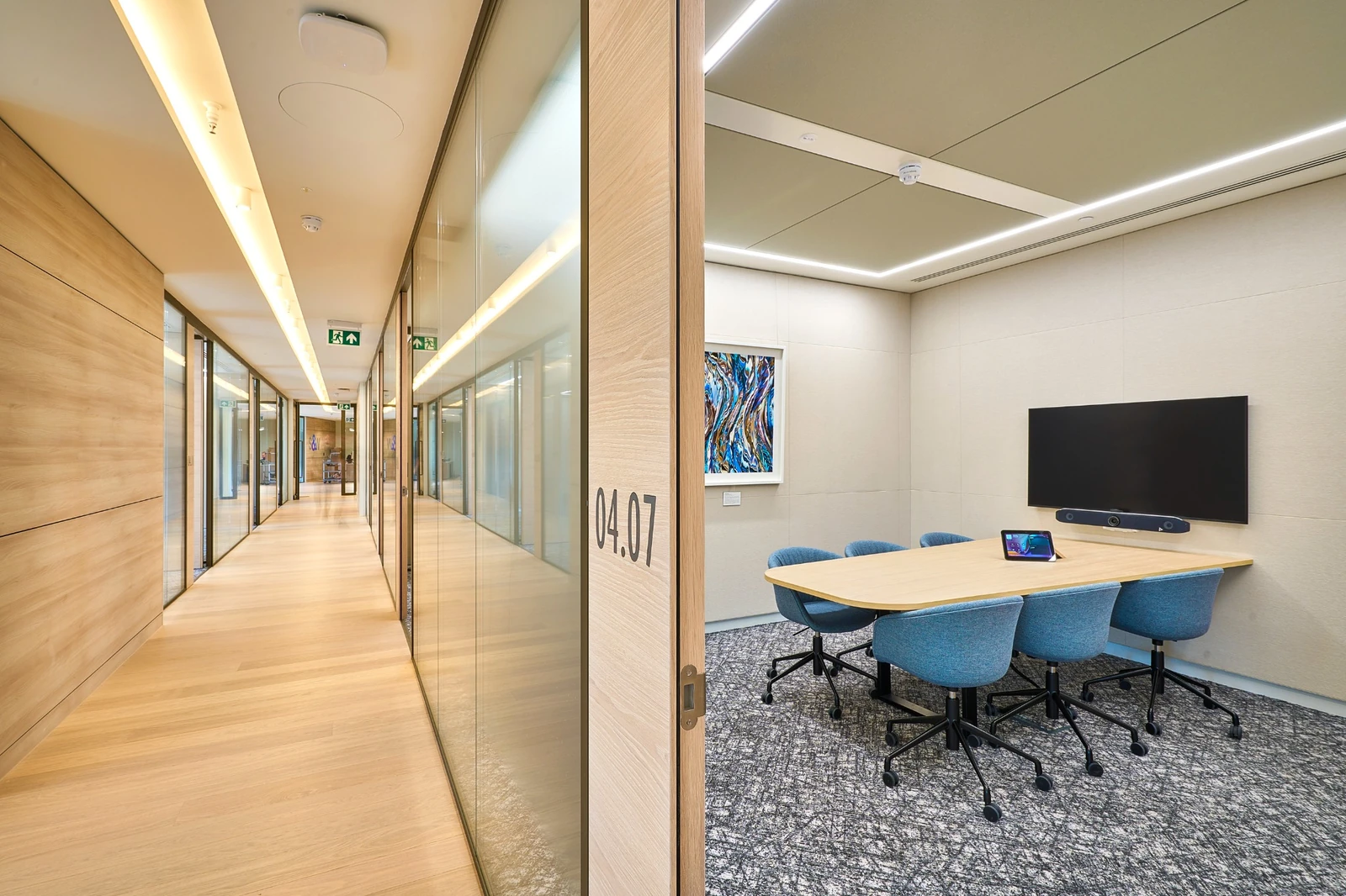Timber-lined corridor with clean junctions at the meeting-room fronts
